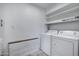 Laundry room with stacked washer and dryer, and shelving for storing laundry products at 1618 W Vernon Ave, Phoenix, AZ 85007