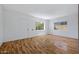 Spacious living room featuring wood-look flooring, fresh white walls, and a back yard view at 1618 W Vernon Ave, Phoenix, AZ 85007