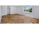 Spacious living room featuring wood-look flooring, fresh white walls, and a front yard view at 1618 W Vernon Ave, Phoenix, AZ 85007