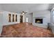Large living room with brick fireplace, tile floor, and backyard access at 1618 W Vernon Ave, Phoenix, AZ 85007
