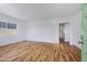 Bright living room with wood-look flooring, fresh white walls, and a view from the large window at 1618 W Vernon Ave, Phoenix, AZ 85007
