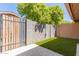 Private backyard with faux grass and tall privacy wall at 1624 E Campbell Ave # 51, Phoenix, AZ 85016