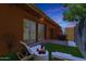 Private backyard with faux grass, stylish lounge furniture, and string lights at 1624 E Campbell Ave # 51, Phoenix, AZ 85016