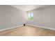 This bedroom has wood floors, neutral paint, and a window offering natural light at 1624 E Campbell Ave # 51, Phoenix, AZ 85016