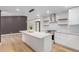 Open concept kitchen with island, stainless appliances, and modern light fixture at 1624 E Campbell Ave # 51, Phoenix, AZ 85016