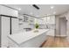 Well-lit kitchen featuring white cabinets, a center island with seating, and stainless steel appliances at 1624 E Campbell Ave # 51, Phoenix, AZ 85016