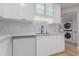 Modern kitchen features sleek white cabinets, quartz counters and stylish backsplash at 1624 E Campbell Ave # 51, Phoenix, AZ 85016