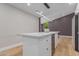 Modern kitchen island with white cabinetry, storage and seating, great for entertaining at 1624 E Campbell Ave # 51, Phoenix, AZ 85016