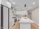 Modern kitchen featuring sleek white cabinetry, stainless steel appliances, and a large center island at 1624 E Campbell Ave # 51, Phoenix, AZ 85016