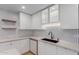 Contemporary kitchen with white cabinetry, sleek counters and hexagon tile backsplash at 1624 E Campbell Ave # 51, Phoenix, AZ 85016