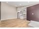 Open-concept living space with hardwood floors and a view of the modern kitchen at 1624 E Campbell Ave # 51, Phoenix, AZ 85016