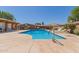 Sparkling community pool with surrounding lounge chairs and manicured landscaping at 1624 E Campbell Ave # 51, Phoenix, AZ 85016