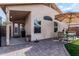 Back patio area with outdoor seating, a brick floor, and a charming exterior at 16654 N 19Th Pl, Phoenix, AZ 85022
