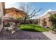 Serene backyard with manicured lawn, patio, landscaping, and shaded seating area at 16654 N 19Th Pl, Phoenix, AZ 85022