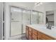 Bathroom with a walk-in shower and modern vanity with wood finish at 16654 N 19Th Pl, Phoenix, AZ 85022