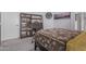 Comfortable bedroom featuring a full bookcase, clock, and stylish London skyline photo at 16654 N 19Th Pl, Phoenix, AZ 85022