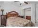 Bedroom featuring matching dressers with a wooden headboard and a spacious closet at 16654 N 19Th Pl, Phoenix, AZ 85022