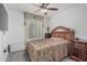 Bedroom featuring a wooden headboard bed, ceiling fan and large window at 16654 N 19Th Pl, Phoenix, AZ 85022