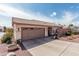 Inviting single-Gathering home featuring a two-car garage, desert landscaping, and a welcoming entryway under a sunny sky at 16654 N 19Th Pl, Phoenix, AZ 85022