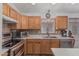 Modern kitchen with stainless steel appliances, wood cabinets, ample counter space, and a sleek design at 16654 N 19Th Pl, Phoenix, AZ 85022