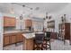 Well-lit kitchen with modern appliances, wood cabinets, and a convenient breakfast bar overlooking the dining area at 16654 N 19Th Pl, Phoenix, AZ 85022