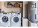 Functional laundry room with washer, dryer, and storage space for household essentials at 16654 N 19Th Pl, Phoenix, AZ 85022