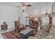 Comfortable living room with tile floors, ceiling fan, and an open layout leading to the kitchen, ideal for entertaining at 16654 N 19Th Pl, Phoenix, AZ 85022