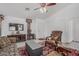 Cozy living room with tile flooring, a ceiling fan, and comfortable seating arrangement under bright lighting at 16654 N 19Th Pl, Phoenix, AZ 85022