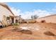 Spacious backyard view with a block wall, a mature tree, and ample space for gardening and outdoor activities at 17128 N Princess Pl, Surprise, AZ 85374