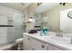 Clean bathroom features modern sink and faucet, white vanity, and a glass-enclosed shower with stylish tile at 17128 N Princess Pl, Surprise, AZ 85374