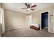 A well-lit bedroom features neutral walls, carpeted floors, and a ceiling fan, creating a cozy atmosphere at 17128 N Princess Pl, Surprise, AZ 85374