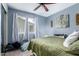 Bedroom with large window providing natural light, ceiling fan, and closet space; a serene retreat at 17128 N Princess Pl, Surprise, AZ 85374