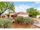 Charming single-story home featuring a red tile roof, desert landscaping, and a cozy front porch at 17128 N Princess Pl, Surprise, AZ 85374