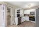 Well-equipped kitchen featuring white cabinets, stainless steel appliances, and a convenient layout at 17128 N Princess Pl, Surprise, AZ 85374