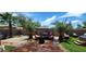 Beautiful backyard features a covered patio, hot tub, tropical trees, and comfortable outdoor seating at 18177 W Tasha Dr, Surprise, AZ 85388