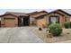 Charming single-story home features a desert landscape, a two-car garage, and a welcoming front entrance at 18177 W Tasha Dr, Surprise, AZ 85388