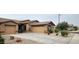 Charming single-story home features a desert landscape, a two-car garage, and a welcoming front entrance at 18177 W Tasha Dr, Surprise, AZ 85388