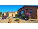 Single-story home with desert landscaping featuring colorful bushes and gravel at 18177 W Tasha Dr, Surprise, AZ 85388