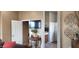Hallway area with view of TV, table decor and entry to bathroom at 18177 W Tasha Dr, Surprise, AZ 85388