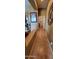 A tiled hallway leads to a laundry room with decorative touches, creating a warm and inviting passage at 18177 W Tasha Dr, Surprise, AZ 85388