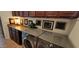 A laundry room is equipped with modern LG machines, wooden cabinets, a counter, and framed wall art at 18177 W Tasha Dr, Surprise, AZ 85388