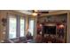 Bright living room featuring an entertainment center and large windows overlooking the landscaped yard at 18177 W Tasha Dr, Surprise, AZ 85388