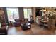 Welcoming living room featuring a cozy leather sofa, elegant decor, and a seamless flow to the dining area at 18177 W Tasha Dr, Surprise, AZ 85388