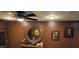 A beautiful living room wall with decorations, including framed pictures, a round mirror, and a cute cat figurine at 18177 W Tasha Dr, Surprise, AZ 85388