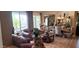 Inviting living room featuring a leather sofa, elegant decor, and views of the outdoor patio at 18177 W Tasha Dr, Surprise, AZ 85388