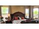 A naturally lit main bedroom features a large, decorative headboard and direct access to the backyard at 18177 W Tasha Dr, Surprise, AZ 85388