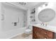 Bright bathroom with white cabinets, shower-tub combo, and updated fixtures at 19018 N Concho Cir, Sun City, AZ 85373