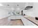 Bright open kitchen with white cabinets, island, and dining area view at 19018 N Concho Cir, Sun City, AZ 85373
