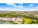 Aesthetic aerial view of residences with serene landscaping, inviting pools, and stunning desert panorama at 20256 E Canary Ct, Queen Creek, AZ 85142
