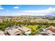 Expansive aerial view of the community showcasing lush greenery, pools, and mountain views at 20256 E Canary Ct, Queen Creek, AZ 85142
